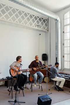 Musicians practicing instruments together in recording studio
