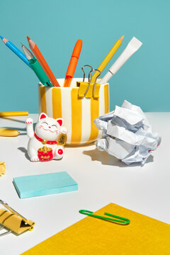 Still life with Stationery and a Lucky Cat Figure on Office Desk