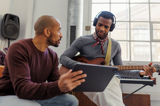 Musicians collaborating on music production in studio