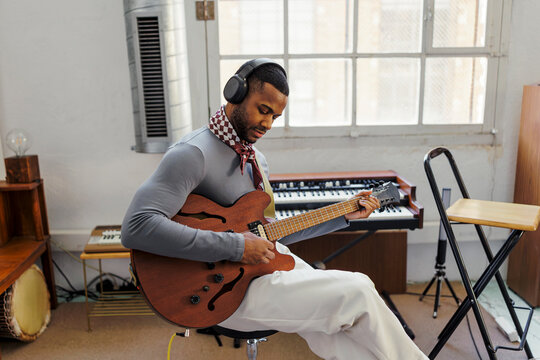 Man playing electric guitar in studio