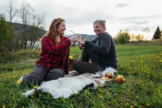 Women enjoying a picnic in nordic meadow