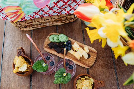 Nordic fika with snacks, drinks and tulips on wooden table