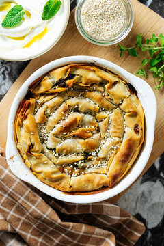 Spiral spinach pie with sesame seeds