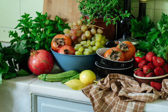 Colorful fresh fruits and herbs on kitchen countertop