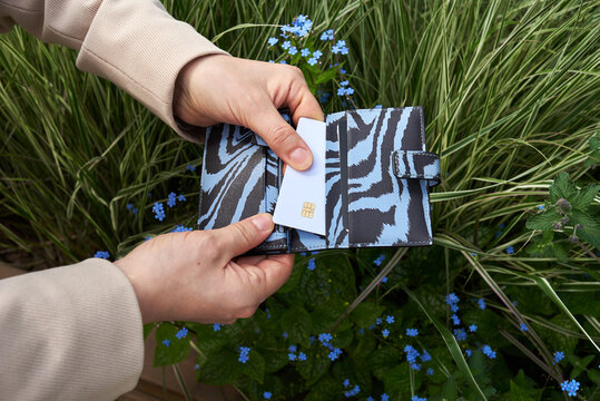 Woman pulls blank сredit card from wallet