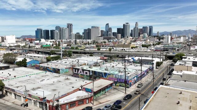 Los Angeles, California, USA - Aerial Drone View of Downtown Urban Skyline, Graffiti-Covered Freeway, High-Rise Buildings, and Busy Cityscape on a Sunny Day