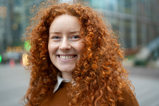Smiling Young Woman With Curly Red Hair