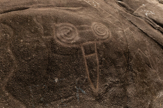 Petroglyph on natural rock with ancestral indigenous figure