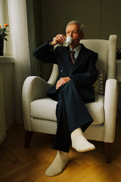 Senior man drinking Turkish coffee by the window