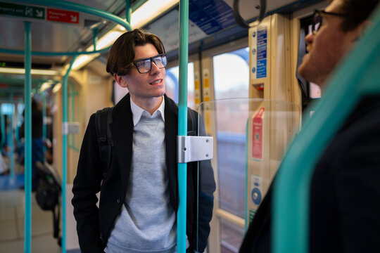 Business colleagues commuting together on public transport