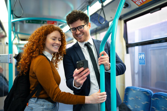 Business colleagues commuting together on public transport