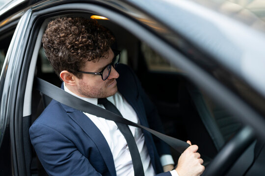 Businessman Fastening Seat Belt Before Driving