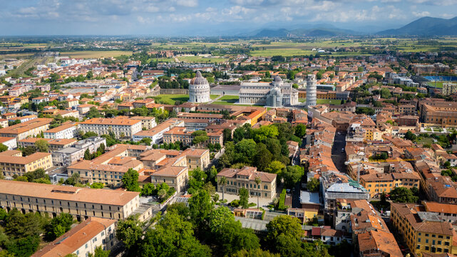 Stunning aerial drone view of the Camposanto with Leaning Tower of Pisa (Torre di Pisa) and Pisa Baptistery of St. John (Battistero di San Giovanni) in Pisa, Italy.