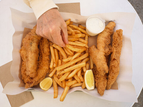 Enjoying Fried Fish & Chips at a Casual Outdoor Dining Spot