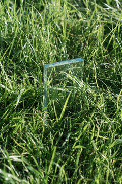 Glass Prism Standing in Green Grass with Sunlight