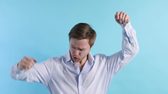 Man with sweaty armpits on light blue background