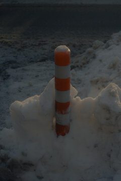 traffic delineator post in winter snow