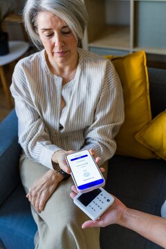 Woman Confirming Mobile Payment