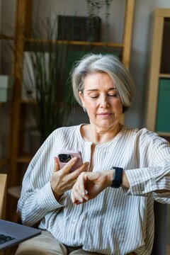 Woman Checking Time And Phone