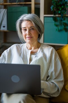 Woman Smiling At Laptop