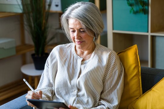 Woman Writing On Tablet