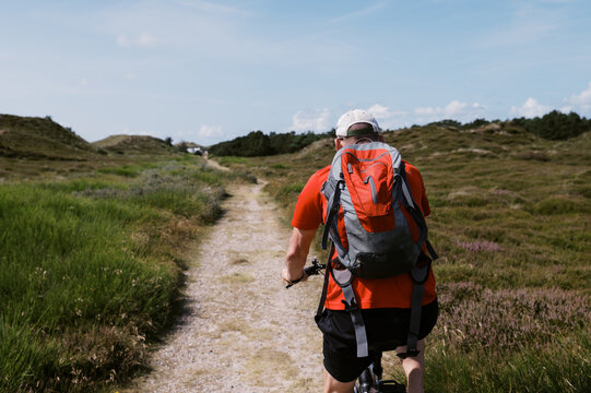 man biking in coastal Denmark on vacation in summer