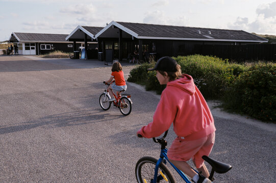 siblings biking on campground in Denmark together