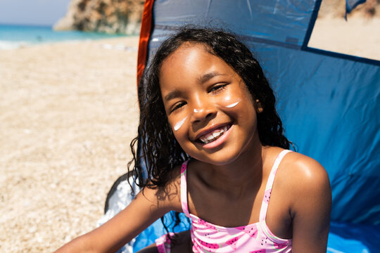 Happy child smiling at the beach during summer vacation