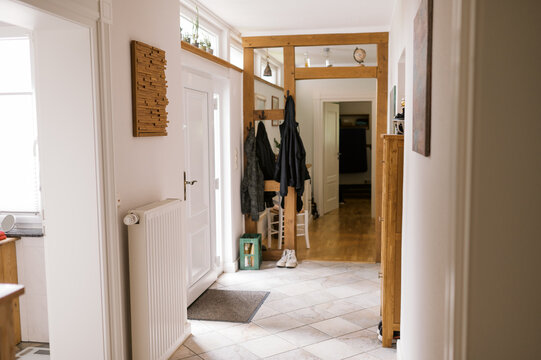 hallway of real home with jackets and shoes and nobody in it