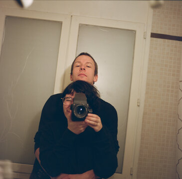 Reflection in the mirror of candid couple in a bathroom