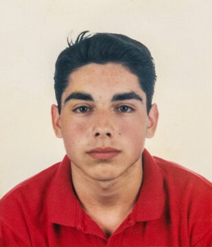 Serious photobooth portrait of teenage boy in the 1990s
