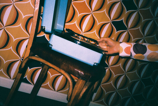 a man is about to play a record on a record player, 35mm film