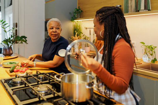 Mother and daughter cooking together in kitchen