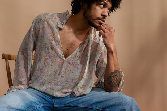 Model Poses in Casual Clothing With a Neutral Background 