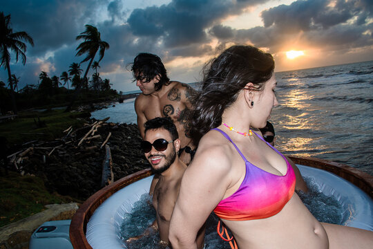 Friends Enjoy Sunset While Relaxing in Hot Tub at the Beach