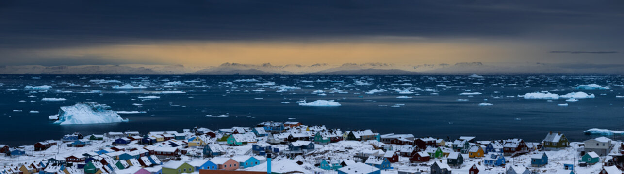 Panorama of GreenlandIc town Ilulissat with icebergs in the sea