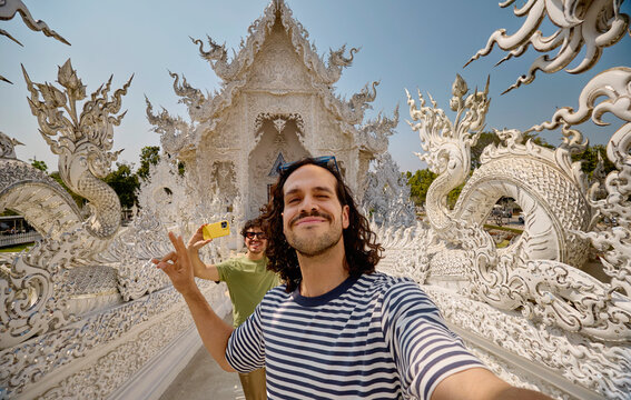 Friends taking selfie at White Temple in Chiang Rai