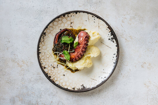 Grilled octopus with mashed potatoes and herb dressing