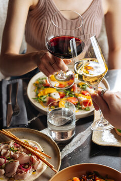 Wine toast over shared meal at restaurant table
