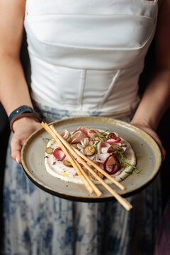 Person Holding Plate with Gourmet Appetizer