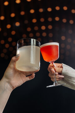 Two People Toasting with Cocktails