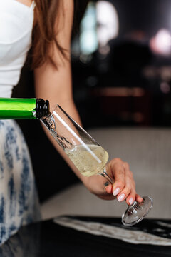 Pouring sparkling wine into a champagne flute 