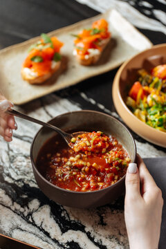 Woman Eating Vegetable Soup with Bruschetta