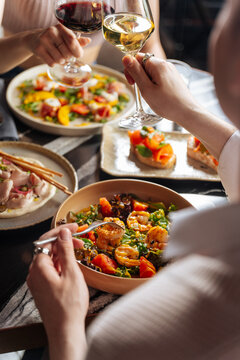 Friends Toasting Wine Over Gourmet Lunch