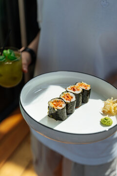 Spicy maki sushi rolls on white plate