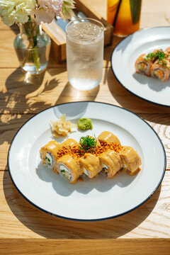 Sushi rolls with creamy sauce and crispy topping