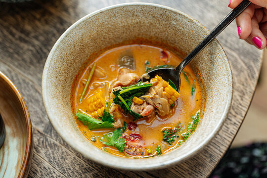 Spicy vegetable soup with corn and herbs