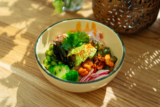 Colorful poke bowl with vegetables and toppings