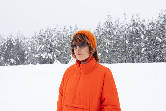 Portrait Of Woman In Orange Winter Jacket With Sunglasses
