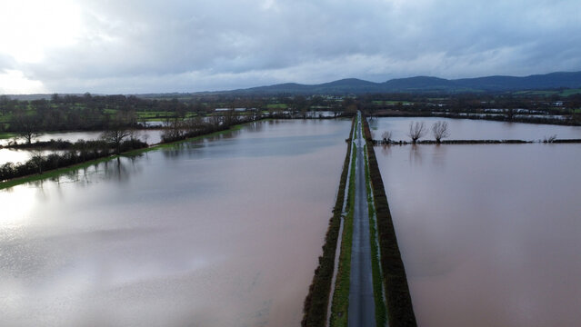 Aerial view of a road through flooded fields in winter